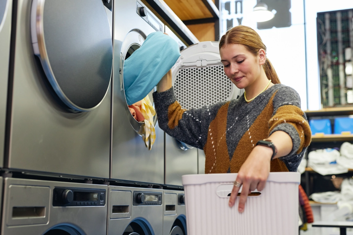 Woman Pulling Clothes Out Of The Dryer 1200X800